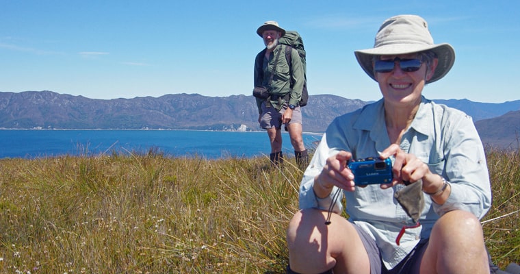 Remote area volunteers, including Andy McQueen and Liz McQueen, can spend up to three weeks tackling weeding out sea spurge along the coastline of Tasmania’s Wilderness World Heritage Area.