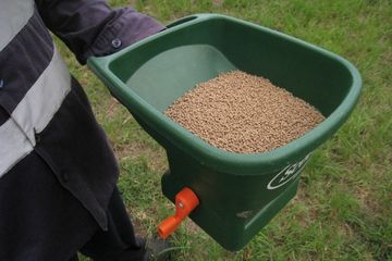 Yellow crazy ant bait spreader.